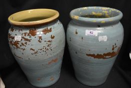Two antique earthen ware pottery storage jars having been later painted