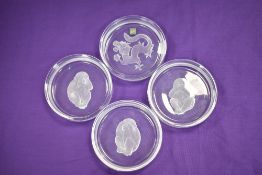 Four modern Hoya crystal glass bowls including dragon and the three monkeys