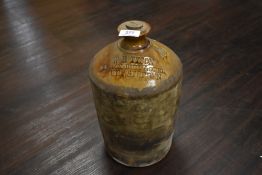 An early 20th century earthen ware advertising flagon for W H Tyson Black Bull Hotel Kirkby Stephen