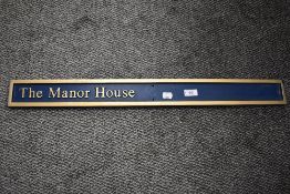 A composite house sign 'The Manor House'.
