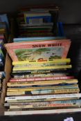 A box of vintage children's annuals and story books including Eagle, Wombles and Dandy