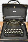An early 20th century L.C Smith and Corona portable typewriter with fitted case