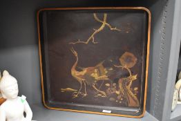 A large late 19th century Japanese lacquer serving tray decorated with stalks and landscape