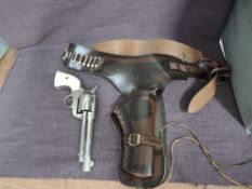 A Denix reproduction Single Action Western Revolver in a tooled leather Holster and Belt