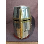 A reproduction medieval Knights Steel Helmet with wooden stand