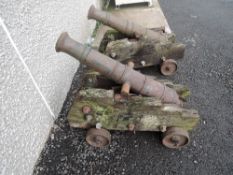 A pair of reproduction cannons on weathered wooden carriages, cannon length 100cm, carriage length