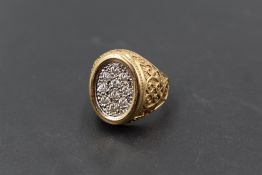 A gent's 14ct gold signet ring having ten pave set cubic zirconia in an oval panel to moulded