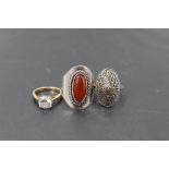 Three silver rings of various forms including Cubic zirconia and stylised
