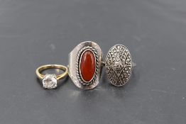Three silver rings of various forms including Cubic zirconia and stylised