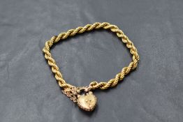 A 15ct gold rope-twist link bracelet, having a 9ct gold heart shaped clasp with filigree type