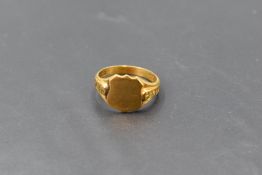 A 9ct gold signet ring, the plain shield form platform between moulded shoulders, the shank