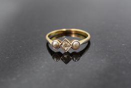 An 18ct gold platinum set diamond and pearl ring, the central brilliant cut stone within a beaded