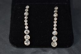 A pair of stud earrings having twenty stone diamond drops, total approx 2.75ct in collared