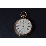 A small yellow metal top wound pocket watch stamped 14K having Roman numeral dial with subsidiary