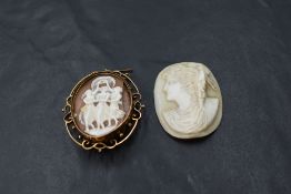 A conch shell cameo brooch depicting the three graces in an open decorative yellow metal brooch