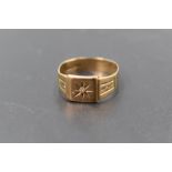 A gent's 9ct gold signet ring having a small inset diamond chip in starburst mount to rectangular