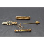 Three yellow metal/9ct gold bar brooches and a stick pin, of various forms, approx 10.5g