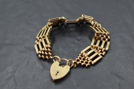 A 9ct gold four bar gate bracelet having padlock clasp, approx 25g