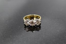 A diamond trilogy ring, total approx 2.20ct in a raised claw set mount on an 18ct gold loop, size
