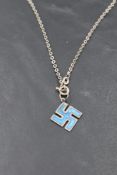 A Charles Horner silver and enamel swastika pendant, marks for Chester 1911, suspended by an oval