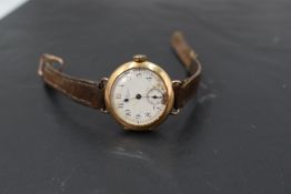 A vintage 9ct gold wrist watch by Waltham USA having Arabic numeral dial with subsidiary seconds