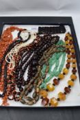 A selection of vintage beads including Baltic amber, branch coral, rough cut amethyst, branch