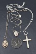 Three silver pendants with chains including cross and locket and a silver medalion presented in 1932