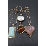 Four silver and white metal pendants, (two with chains) of various forms, including rose quartz,