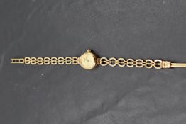 A lady's 9ct gold wristwatch by Geneve having baton numeral dial to oval face on 9ct gold bracelet