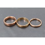 A group of three 9ct gold wedding bands of plain form, sizes M/T & approx 8g
