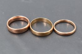 A group of three 9ct gold wedding bands of plain form, sizes M/T & approx 8g