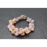 A multi stone polished pebble agate bracelet with crystal bead and loop clasp