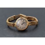 A vintage 9ct gold wrist watch having Arabic numeral dial with subsidiary seconds in gold case on