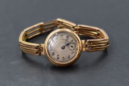 A vintage 9ct gold wrist watch having Arabic numeral dial with subsidiary seconds in gold case on