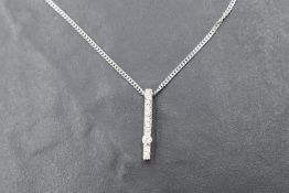 An Italian 18ct white gold diamond pendant with chain having a tension set diamond amongst 10