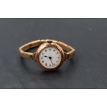 A lady's vintage 9ct rose gold wrist watch having Arabic numeral dial with gilt minute dots to white