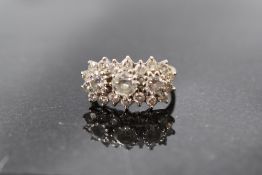 A diamond triple cluster ring having three central diamonds, total approx 1.5ct within a border of