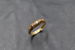 A Victorian 5 stone diamond chip ring in a multi claw gallery mount on an 18ct gold loop, size L &