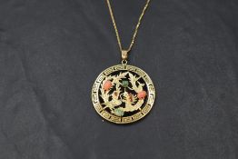 An Oriental Phoenix & Dragon pendant having coral, jade and ruby chip decoration on a black