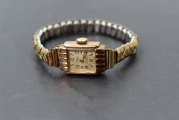 A lady's vintage 9ct gold wrist watch by Majex having baton & Arabic numeral dial to square face
