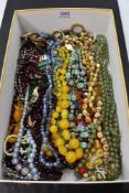 A selection of vintage strings of beads including Scarab style, glass, horn, etc