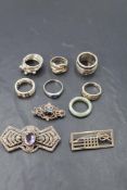 A small selection of HM silver and white metal rings and brooches of various forms