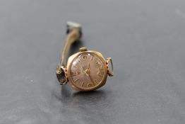 A lady's vintage 9ct gold wrist watch by Tissot having baton and Arabic numeral dial and leather