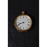 A small yellow metal top wound pocket watch stamped 18K having Roman numeral dial in extensively