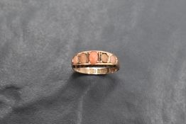 An Edwardian 5 stone coral cabochon ring having gallery mount on 9ct gold loop, size N & approx 2.1g