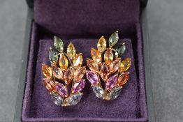 A pair of multi coloured (fancy) sapphire set stud earrings in the form of leaves in 9ct gold open