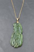 A carved jade pendant with yellow metal loop stamped 14K on an 8ct gold chain, approx 20' & GW 14.