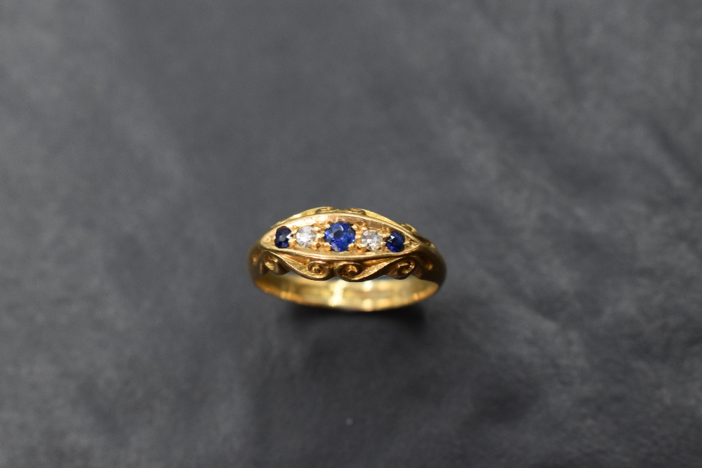 An 18ct gold diamond and sapphire ring, a linear arrangement of five stones within an elliptical - Image 2 of 3