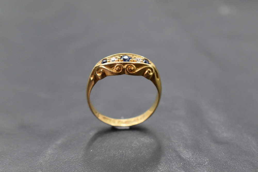 An 18ct gold diamond and sapphire ring, a linear arrangement of five stones within an elliptical - Image 3 of 3