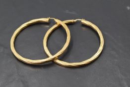 A pair of 9ct gold oversized twist hoop earrings, approx 10g